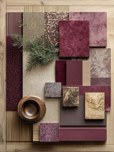 an arrangement of different colors and patterns on a wooden surface with a bowl in the middle