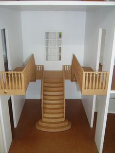 there is a doll house with stairs to the second floor