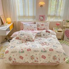 a bed room with a neatly made bed and hello kitty comforter