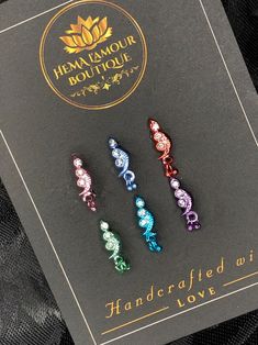 three different colored hair clips sitting on top of a black card with the words hemamour boutique