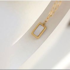 Delicate and understated, this Square Mother of Pearl Pendant Necklace will add a touch of elegance to any outfit. The 18k gold plating and stainless steel construction mean it's durable enough for everyday wear, while the mother-of-pearl pendant provides just the right amount of sparkle. Dainty Pearl Necklace, Mother Of Pearl Pendant, Real Pearl Necklace, Stacked Necklaces, 18k Gold Necklace, Hypoallergenic Jewelry, Square Pendant, Allergic Reaction, Real Pearls