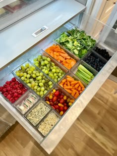 a display case filled with lots of different fruits and vegetables