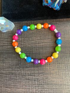 Cute stretch bracelet made with plastic rainbow beads and white seed beads. This bracelet is perfect for rainbow lovers, Pride, raves and any other occasion!  * All materials were cleaned and sanitized prior to use and kept in a clean smoke free environment. Comes packaged in a mesh drawstring bag. Handmade Funky Rainbow Bracelets, Cheap Cute Rainbow Bracelets, Cheap Novelty Rainbow Beaded Bracelets, Cheap Rainbow Colored Plastic Stretch Bracelet, Vibrant Rainbow Bracelets With Colorful Beads, Rainbow Beaded Bracelets For Gifts, Rave Style, Fun Rainbow Colored Plastic Bracelets, Gods Promise, Kawaii Bracelet