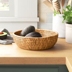 an avocado in a woven bowl on a kitchen counter