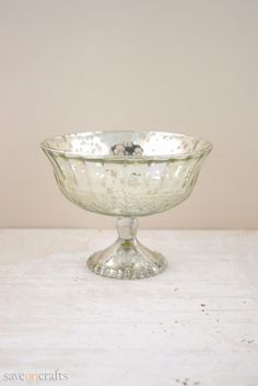 a glass bowl sitting on top of a white table