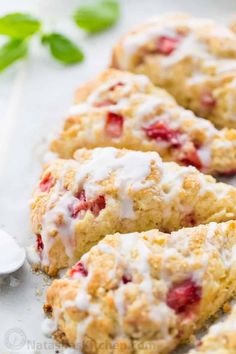 strawberry scones with icing on a white plate