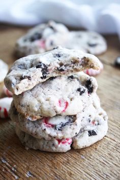 three cookies stacked on top of each other with candy canes in the middle and one cookie half eaten