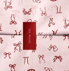 a red tag on a pink and white patterned fabric