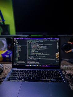 an open laptop computer sitting on top of a table