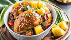 a white bowl filled with chicken, pineapples and green beans on top of a wooden plate