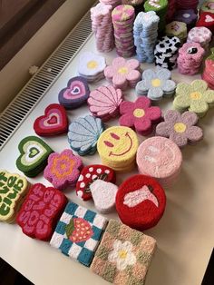 several decorated cookies are sitting on a table with other cookie items around them, including flowers and hearts