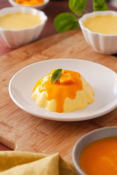 small desserts with orange sauce on a wooden table