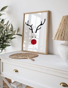 a white dresser topped with a mirror and a deer's head