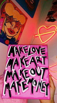 someone holding up a pink box with writing on it that says make out mateoney