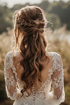 a woman with long hair wearing a white dress and braid in her hair, looking off to the side