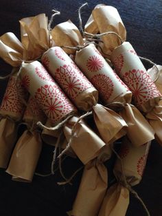 four rolls of brown paper wrapped in twine and tied with twine on a table