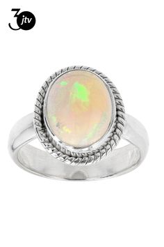 a white ring with an oval shaped opal in the center and rope band around it