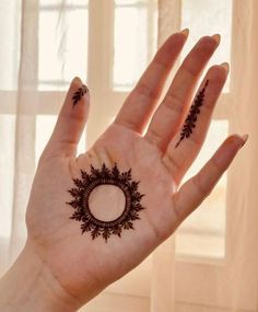 a woman's hand with hennap on it and an open circle around the palm