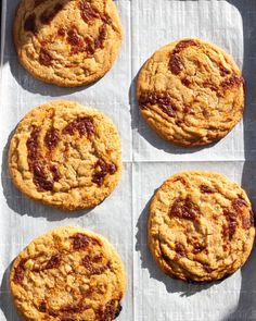 four cookies sitting on top of a white paper