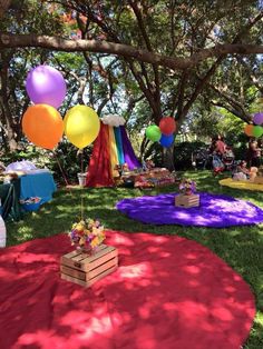 an outdoor party with colorful balloons and decorations