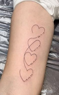 a woman's arm with two hearts and the word love written in cursive writing