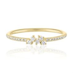 a yellow gold ring with two small diamonds on the top and one smaller diamond in the middle