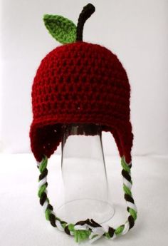 a crocheted hat with a green leaf on top