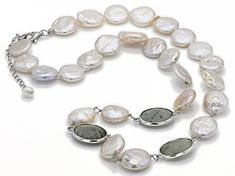 12-13mm & 4-5mm white cultured freshwater pearl with labradorite rhodium over silver necklace. Measures approximately 1/2" in width and has a lobster claw clasp. Colors, shapes, and sizes may vary. Silver Oval Pearl Drop Necklace, Silver Oval Necklace With Pearl Drop, Silver Pearl Necklace With Gemstone, Silver Pearl Necklace With Gemstone Beads, Oval Silver Pearl Necklace, Silver Oval Pearl Necklaces, White Round Pearl Necklace With Natural Stones, White Pearl Necklace With Natural Stones, Silver Single Strand Oval Necklace