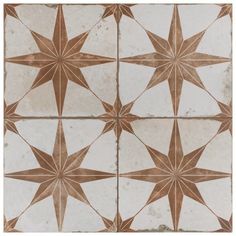 a tile pattern with brown and white stars on the top, as if it were from an antique book