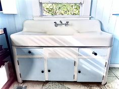 an old fashioned sink in a blue bathroom