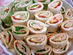 a platter filled with lots of different types of sandwiches