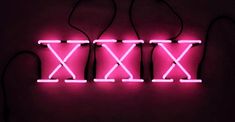 three neon lights that are connected to each other in the shape of x on a wall