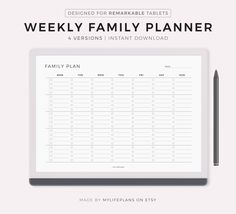 the weekly family planner is shown with a pen on top of it and an empty notepad