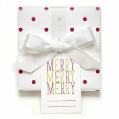 a christmas card with a white bow and red polka dots on it, next to a tag that says merry merry