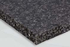 a close up view of the surface of a piece of black rock - type material