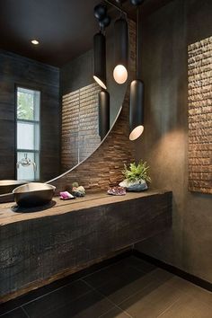 a bathroom with a large mirror and two lights hanging from it's side wall