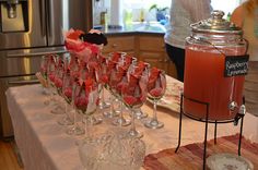 there are many wine glasses on the table and one is filled with watermelon