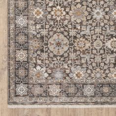 an area rug with many different colors and patterns on the floor, including brown, beige, blue, gray and white