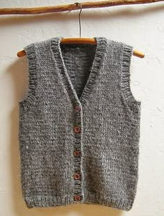 a gray sweater vest hanging on a clothes line