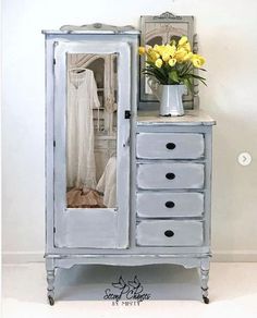 a white cabinet with yellow flowers in it