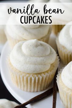 vanilla bean cupcakes on a white plate with cinnamon sticks