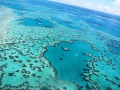 an aerial view of the great barrier reef in the middle of the ocean with blue water