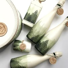 four green and white vases sitting next to each other on top of a table