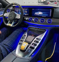 the interior of a car with blue leather and black trims, including steering wheel