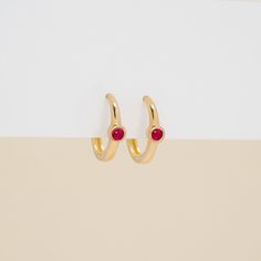 Embrace the beauty of natural gemstones with these stunning huggie earrings. Each earring showcases a genuine, natural ruby in a classic bezel setting, its rich color contrasting beautifully against the warmth of solid gold. These earrings embody timeless style and exquisite craftsmanship. - Handmade - Solid Gold - Natural Ruby  - Total Ruby Carat Weight: 0.07 ctw - Outer Diameter: 11 mm - Inner Diameter: 8.5 mm - Bezel Dimension: 2.6 mm * Sold as a pair *  🛠 Your Sarah Elise piece is handcraft Elegant Hoop Huggie Earrings With Birthstone, Elegant Birthstone Huggie Hoop Earrings, Small Hoop Huggie Earrings With Gemstones For Anniversary, Fine Jewelry Small Hoop Gemstone Earrings, Huggy Earrings, Memory Ring, Gold Huggies, Solid Gold Bracelet, Small Gold Hoops