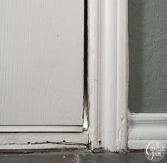 an open white door on a gray wall