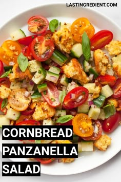 cornbread panzanella salad on a white plate with the words cornbread panzanella salad