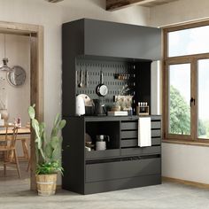 a black cabinet with utensils on it next to a potted plant