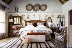 a bed sitting in a bedroom next to a chair and table on top of a rug