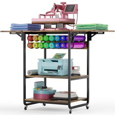 a sewing machine sitting on top of a shelf filled with different types of fabric and supplies